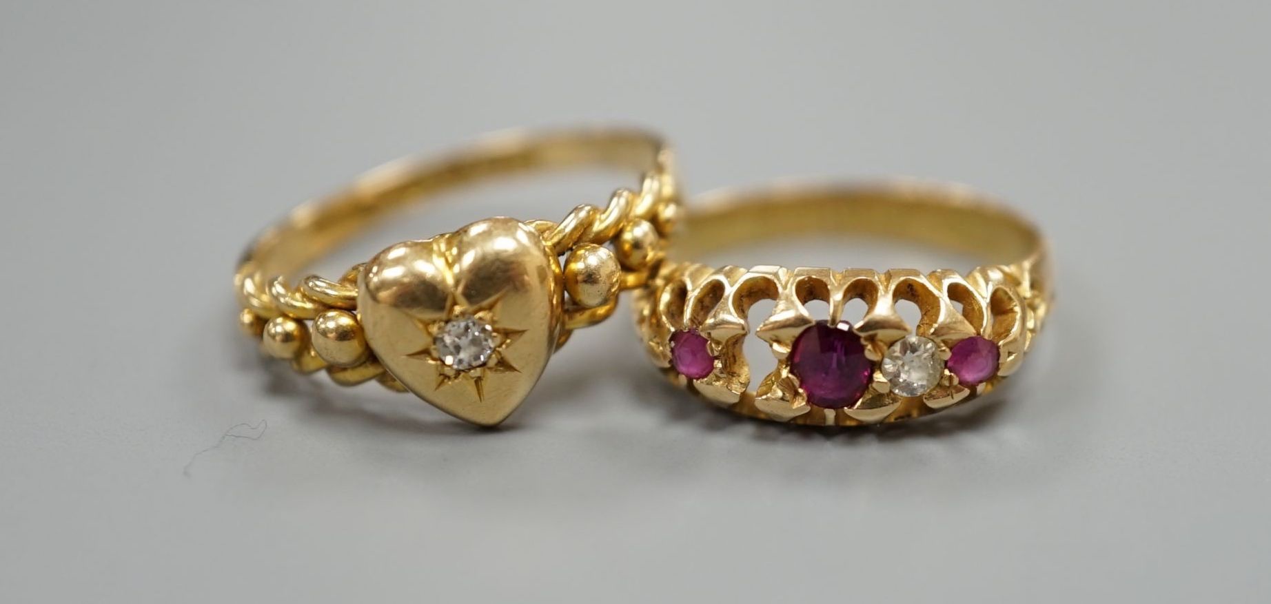 Two early 20th century 18t gold and gem set ring, including heart shape with diamond, sizes N/O and L, (stone missing), gross 5.2 grams.